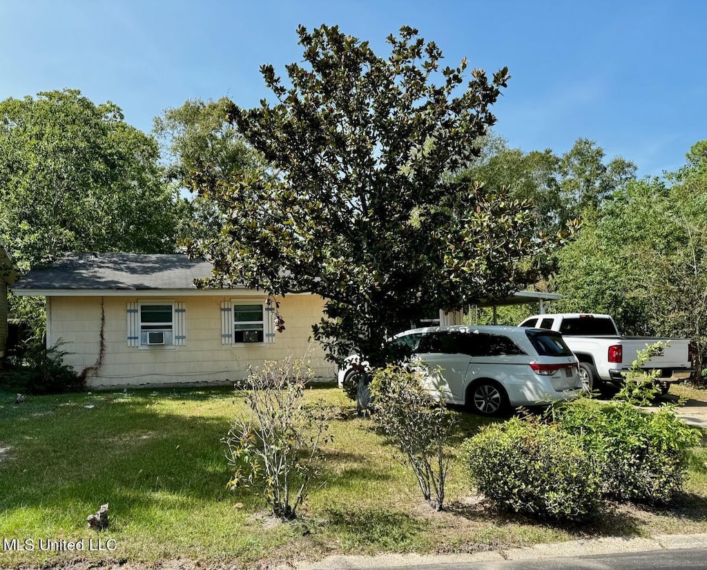 view of home's exterior with cooling unit and a yard