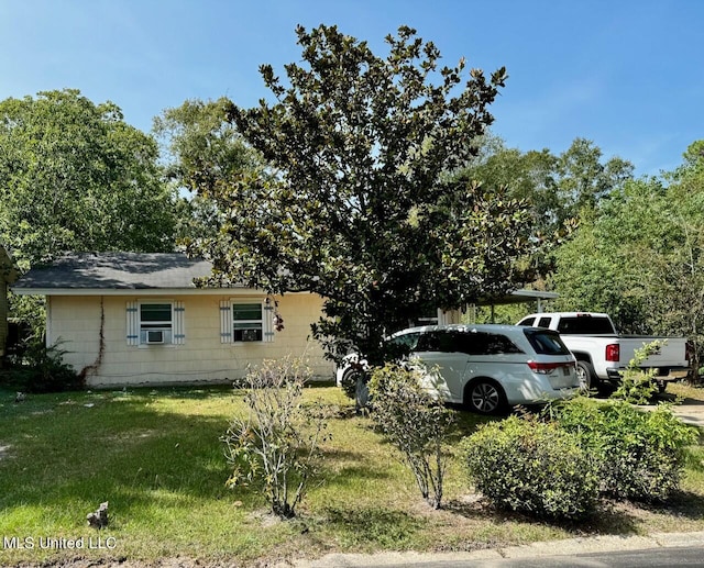 view of home's exterior with cooling unit and a yard