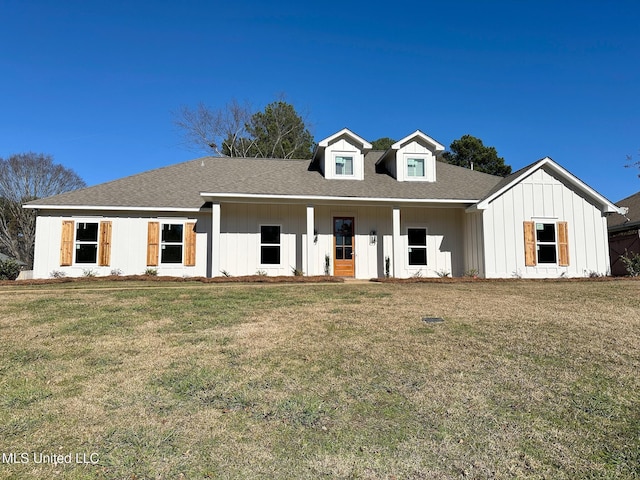 modern farmhouse style home with a front lawn