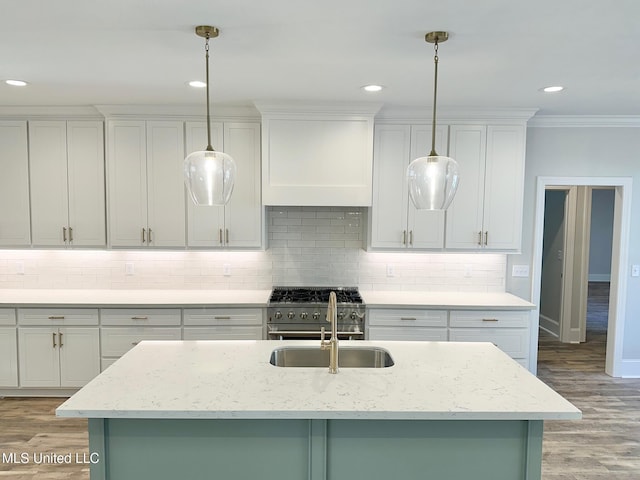 kitchen featuring light hardwood / wood-style flooring, light stone counters, and hanging light fixtures