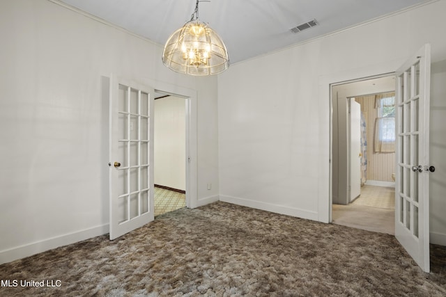 2900 7th Ave, Gulfport, MS 39501 - spare room featuring french doors, a chandelier, carpet flooring, baseboards, and ornamental molding