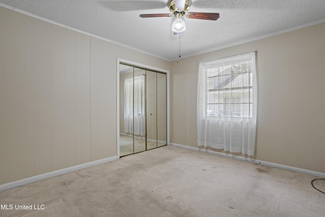 2900 7th Ave, Gulfport, MS 39501 - unfurnished bedroom featuring a textured ceiling, carpet floors, a closet, ornamental molding, and a ceiling fan