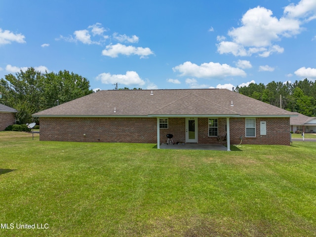 1104 SE 2nd St, Magee, MS 39111 - rear view of house with a patio, a lawn, brick siding, and a shingled roof