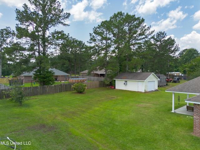 1104 SE 2nd St, Magee, MS 39111 - view of yard featuring an outdoor structure and a detached garage
