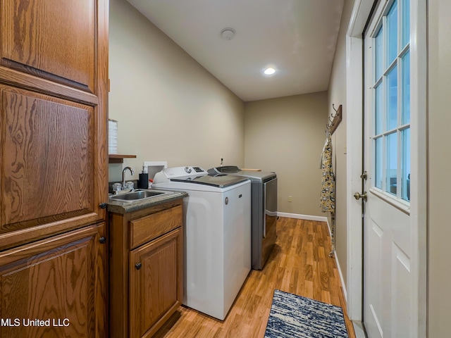 1104 SE 2nd St, Magee, MS 39111 - washroom featuring light wood-style flooring, separate washer and dryer, cabinet space, recessed lighting, and baseboards
