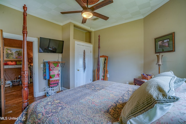 bedroom with crown molding, wood-type flooring, and ceiling fan