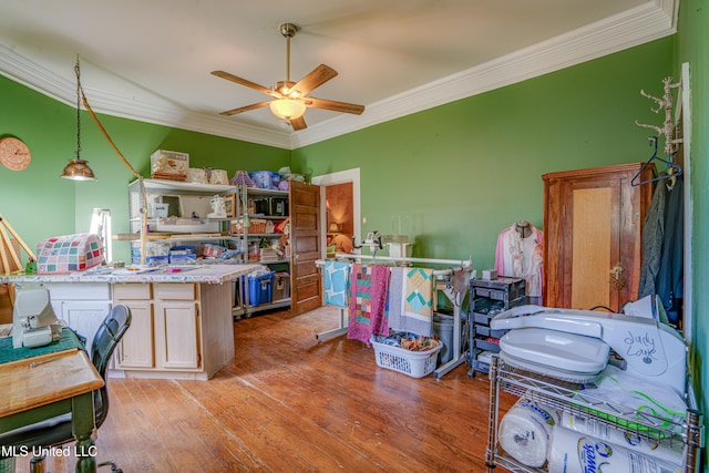 interior space featuring light hardwood / wood-style floors, ornamental molding, and ceiling fan