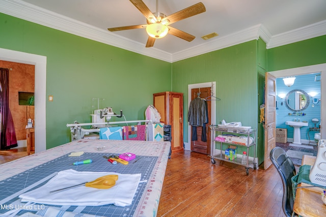 bedroom featuring ceiling fan, hardwood / wood-style flooring, and ornamental molding