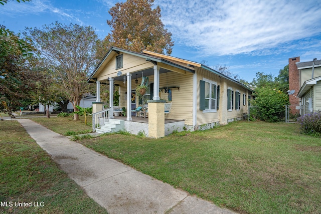 bungalow-style house with a front yard and covered porch