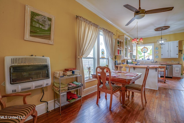 3508 11th St, Gulfport, MS 39501 - dining room featuring heating unit, ornamental molding, wood-type flooring, a ceiling fan, and baseboards