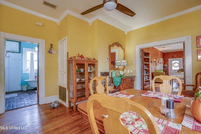 dining room featuring ornamental molding, hardwood / wood-style floors, and ceiling fan