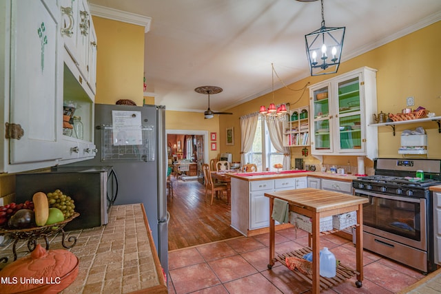 kitchen featuring appliances with stainless steel finishes, white cabinetry, light hardwood / wood-style flooring, crown molding, and decorative light fixtures