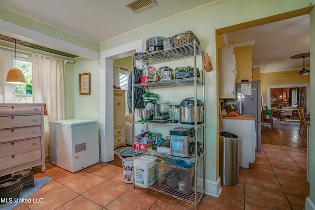 interior space featuring light hardwood / wood-style floors, crown molding, and ceiling fan