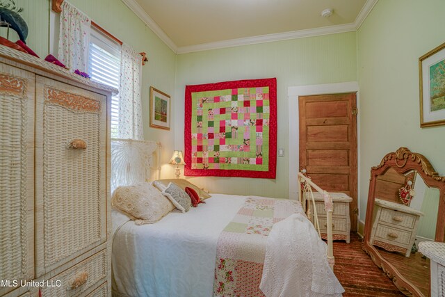 bedroom featuring wood-type flooring and ornamental molding