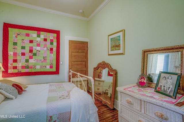 bedroom featuring ornamental molding and hardwood / wood-style flooring