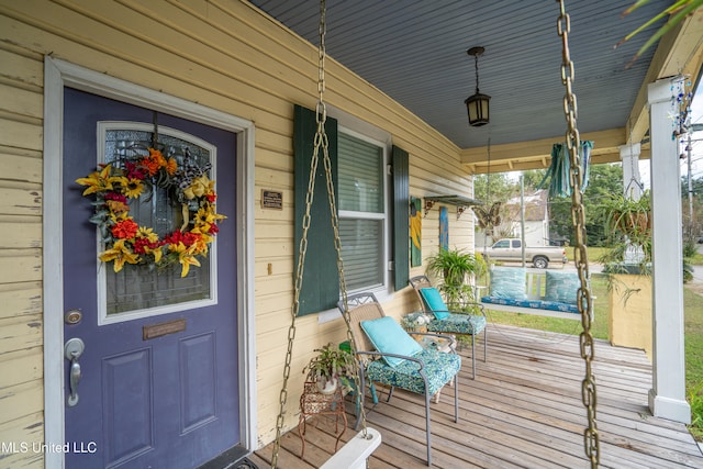 view of exterior entry with a porch