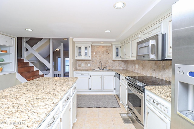 65 Breakers Ln, Ridgeland, MS 39157 - kitchen featuring stainless steel appliances, a sink, backsplash, light tile patterned floors, and light stone counters