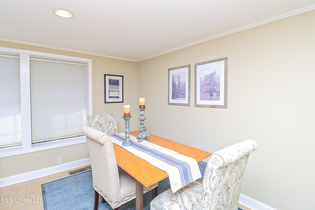 dining space featuring tile patterned flooring and ornamental molding