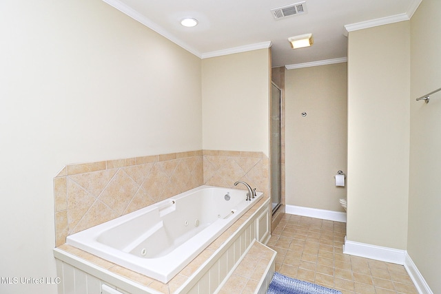 bathroom with tile patterned floors, toilet, crown molding, and tiled tub