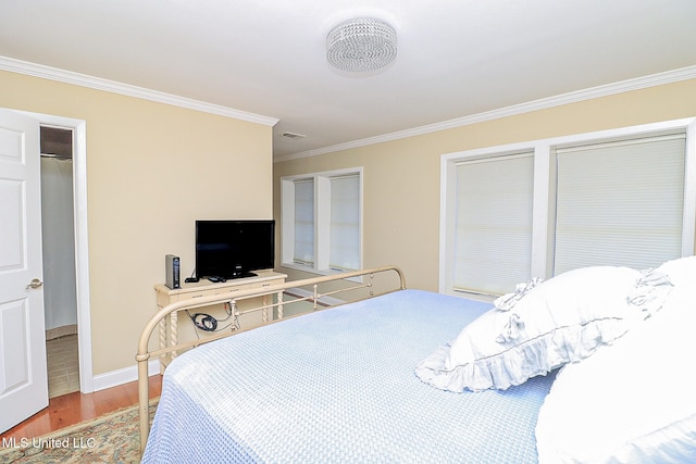 bedroom with ornamental molding and light hardwood / wood-style flooring