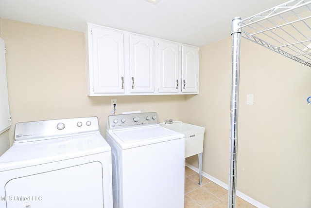 washroom with cabinets, separate washer and dryer, sink, and light tile patterned floors