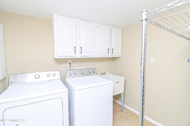 65 Breakers Ln, Ridgeland, MS 39157 - washroom with cabinet space, washing machine and dryer, light tile patterned flooring, and baseboards