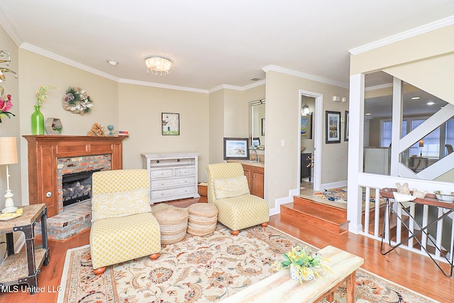 65 Breakers Ln, Ridgeland, MS 39157 - living room with light wood-type flooring, ornamental molding, baseboards, a brick fireplace, and stairway