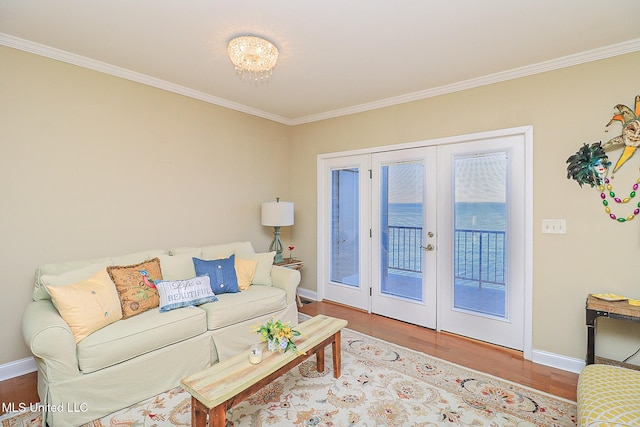 living room with hardwood / wood-style floors, ornamental molding, and french doors