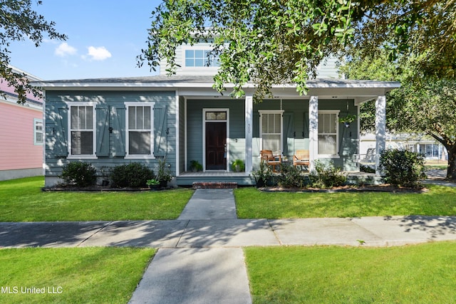 bungalow featuring a front yard and covered porch