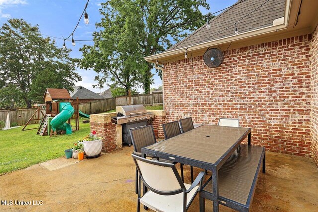 208 Grand Oak Blvd, Clinton, MS 39056 - view of patio with an outdoor kitchen, a fenced backyard, outdoor dining area, and a playground
