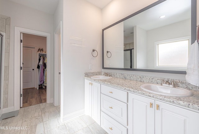 bathroom featuring vanity and an enclosed shower