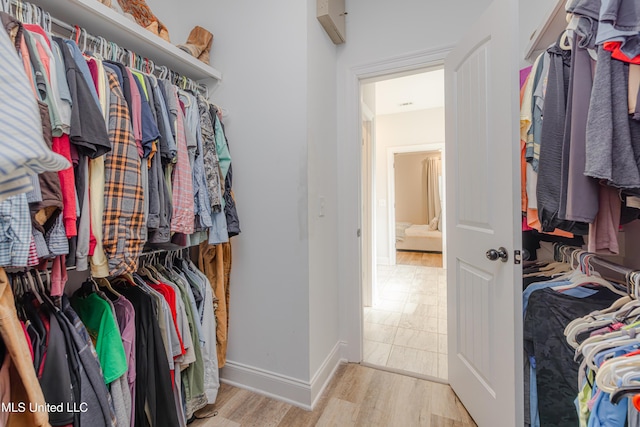 walk in closet featuring light hardwood / wood-style flooring