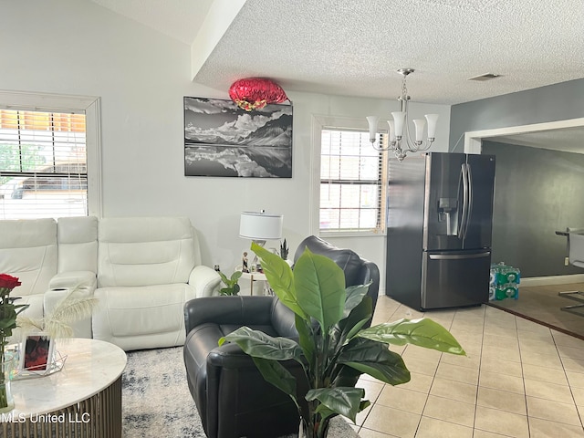 living room with a wealth of natural light, light tile patterned flooring, and a textured ceiling