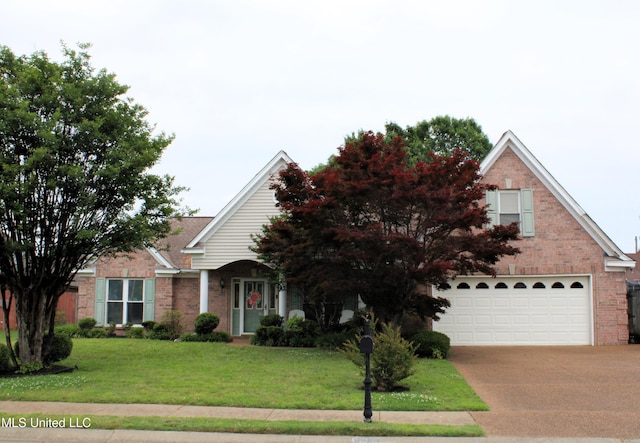 6904 Braybourne Main, Olive Branch, MS 38654 - view of front of home featuring an attached garage, brick siding, driveway, and a front lawn