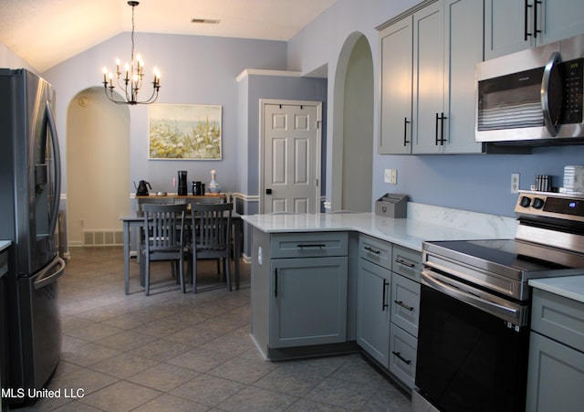 6904 Braybourne Main, Olive Branch, MS 38654 - kitchen with stainless steel appliances, gray cabinets, arched walkways, a peninsula, and a chandelier