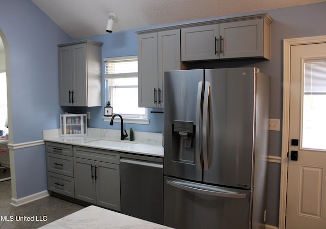 6904 Braybourne Main, Olive Branch, MS 38654 - kitchen featuring stainless steel fridge, dishwasher, a sink, gray cabinets, and arched walkways