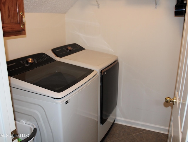 6904 Braybourne Main, Olive Branch, MS 38654 - laundry room with washer and dryer, cabinet space, dark tile patterned floors, a textured ceiling, and baseboards