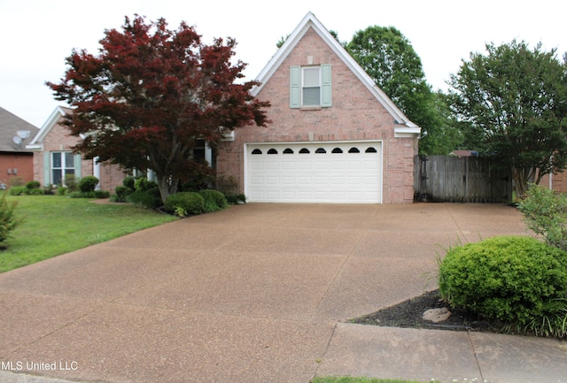 6904 Braybourne Main, Olive Branch, MS 38654 - traditional-style house with driveway, brick siding, and a garage