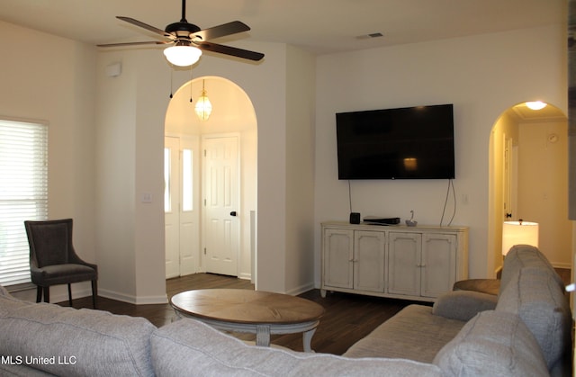 6904 Braybourne Main, Olive Branch, MS 38654 - living area featuring arched walkways, ceiling fan, dark wood-style flooring, and healthy amount of natural light