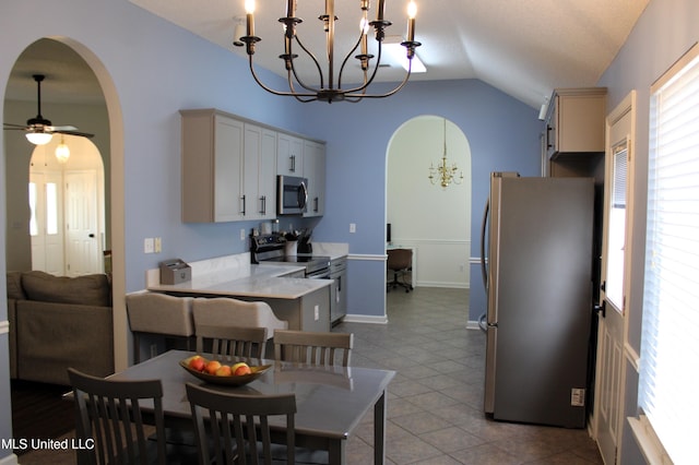 6904 Braybourne Main, Olive Branch, MS 38654 - dining area featuring arched walkways, a chandelier, vaulted ceiling, ceiling fan, and baseboards