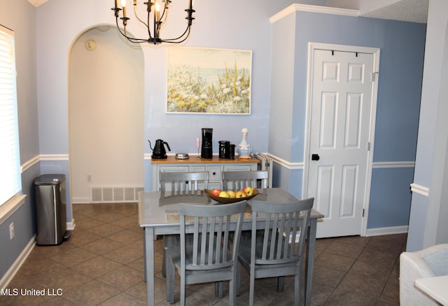 6904 Braybourne Main, Olive Branch, MS 38654 - dining area featuring a chandelier, tile patterned flooring, and baseboards