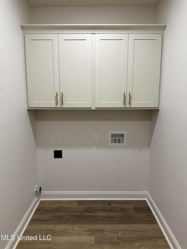 laundry area with hookup for a washing machine, dark wood-style floors, cabinet space, baseboards, and hookup for an electric dryer