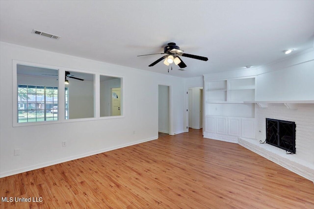 unfurnished living room featuring light hardwood / wood-style floors, a fireplace, and ceiling fan