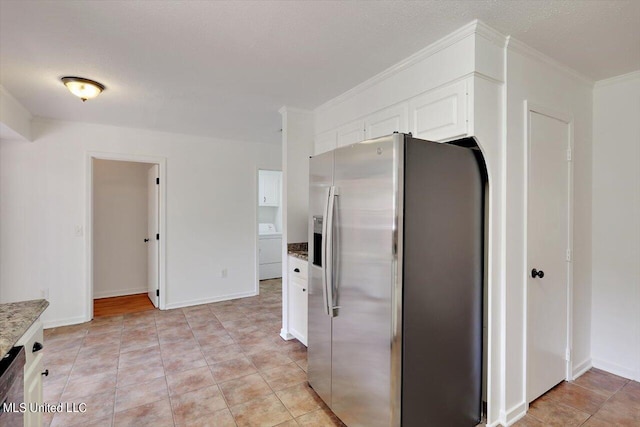 kitchen with washer / clothes dryer, white cabinetry, a textured ceiling, crown molding, and stainless steel appliances