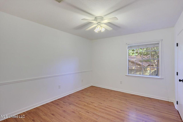 spare room with ceiling fan, a textured ceiling, and light hardwood / wood-style flooring