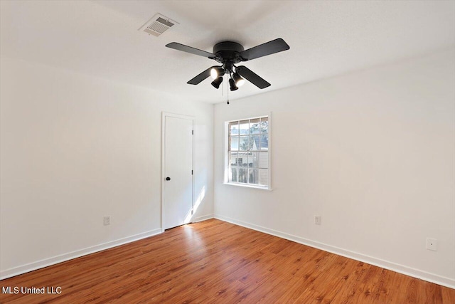 unfurnished room featuring ceiling fan and hardwood / wood-style floors