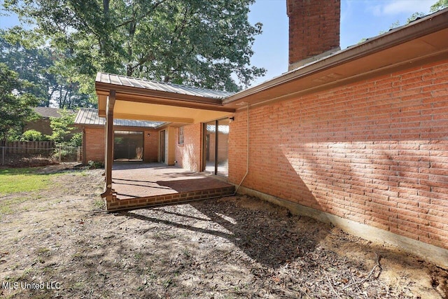 view of property exterior with a patio area