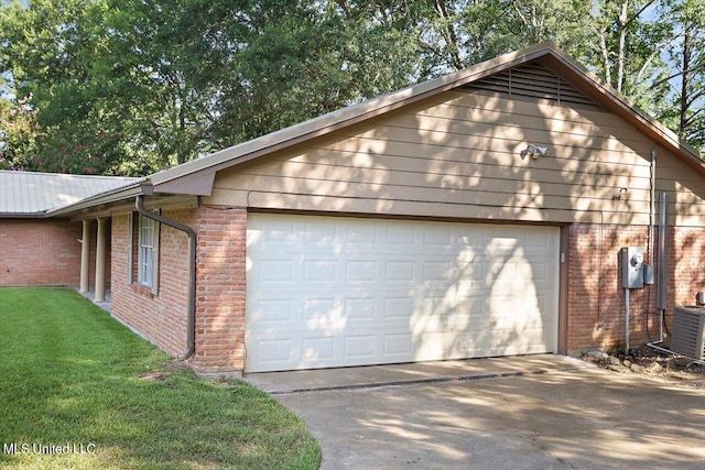 view of side of home featuring a yard, central air condition unit, and a garage