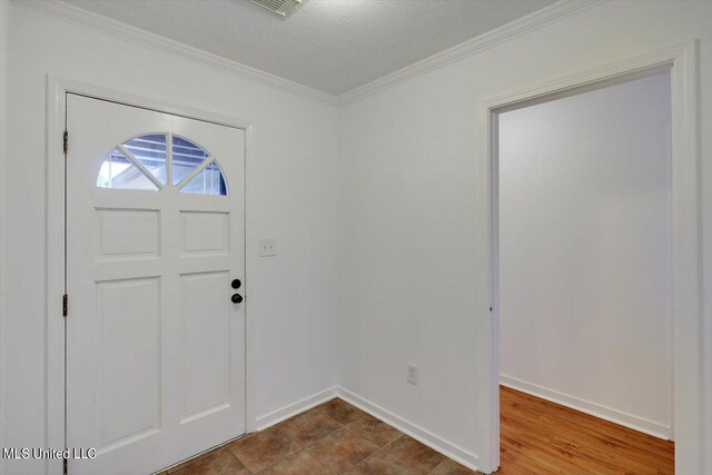 603 Herndon Hl, Clinton, MS 39056 - foyer featuring ornamental molding, baseboards, and a textured ceiling