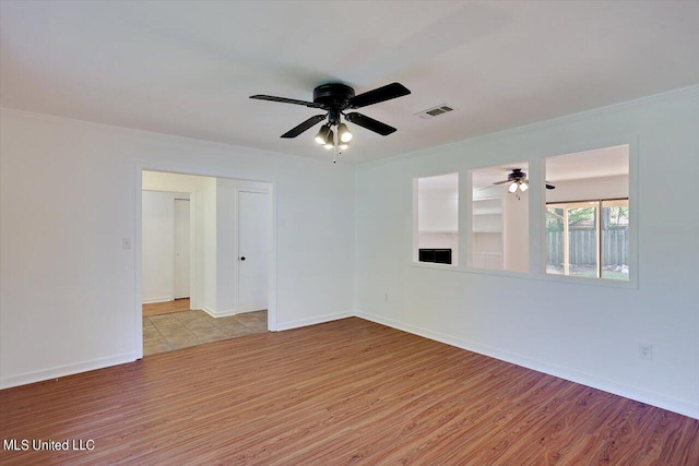 603 Herndon Hl, Clinton, MS 39056 - unfurnished room with ceiling fan, light wood-style floors, crown molding, and baseboards